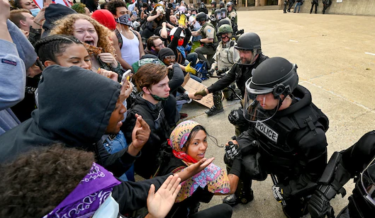 Police kneel before protesters in Spokane, Washington, USA.