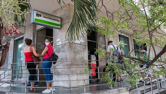 Cubanos en un banco en La Habana.
