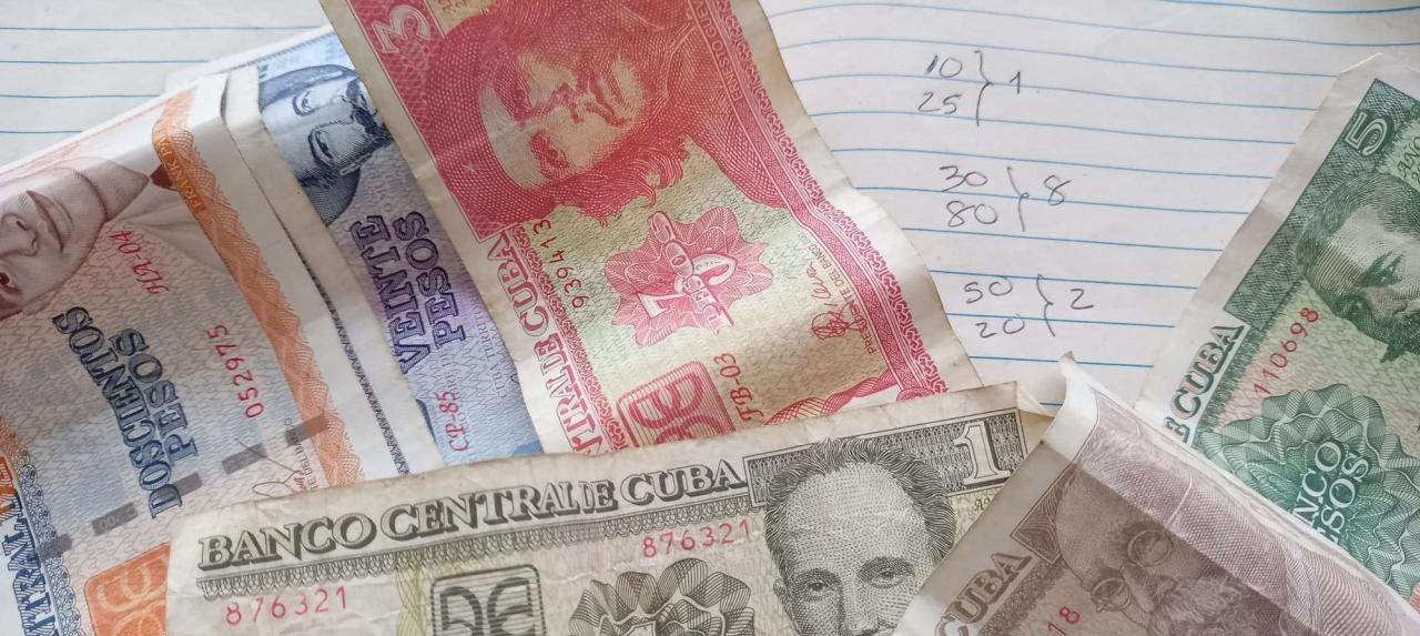 Billetes cubanos con apuntes de apuestas.
