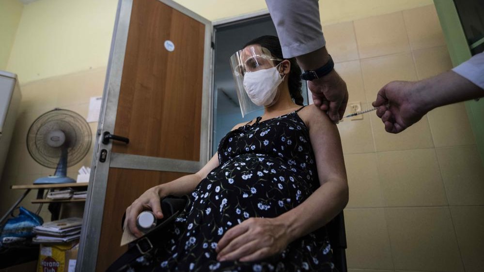 An expecting woman receives a dose of Cuba's Abdala vaccine against COVID-19 at a clinic in Havana, Cuba, on Thursday, August 5, 2021.