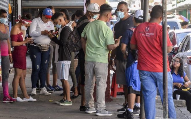 Cubans buying cell phones at the Mercado Oriental, Managua, Nicaragua. 