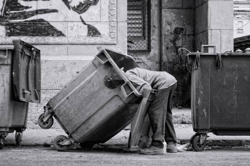 A man rummaging through a garbage bin, Old Havana, 2016. 