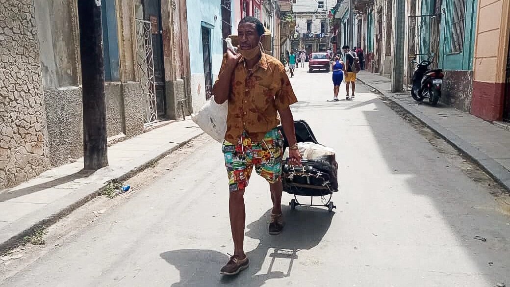 A man drags a suitcase in Havana.