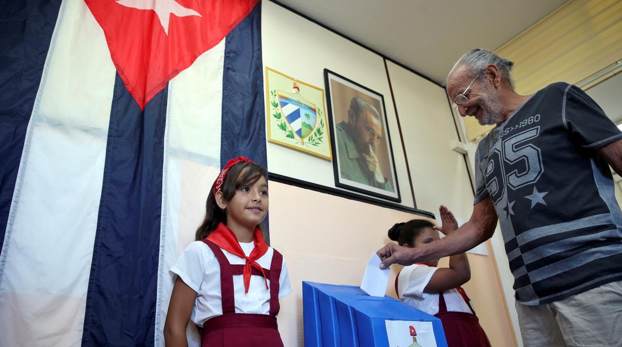 Ballot boxes and "pioneers" at a polling station in Cuba.