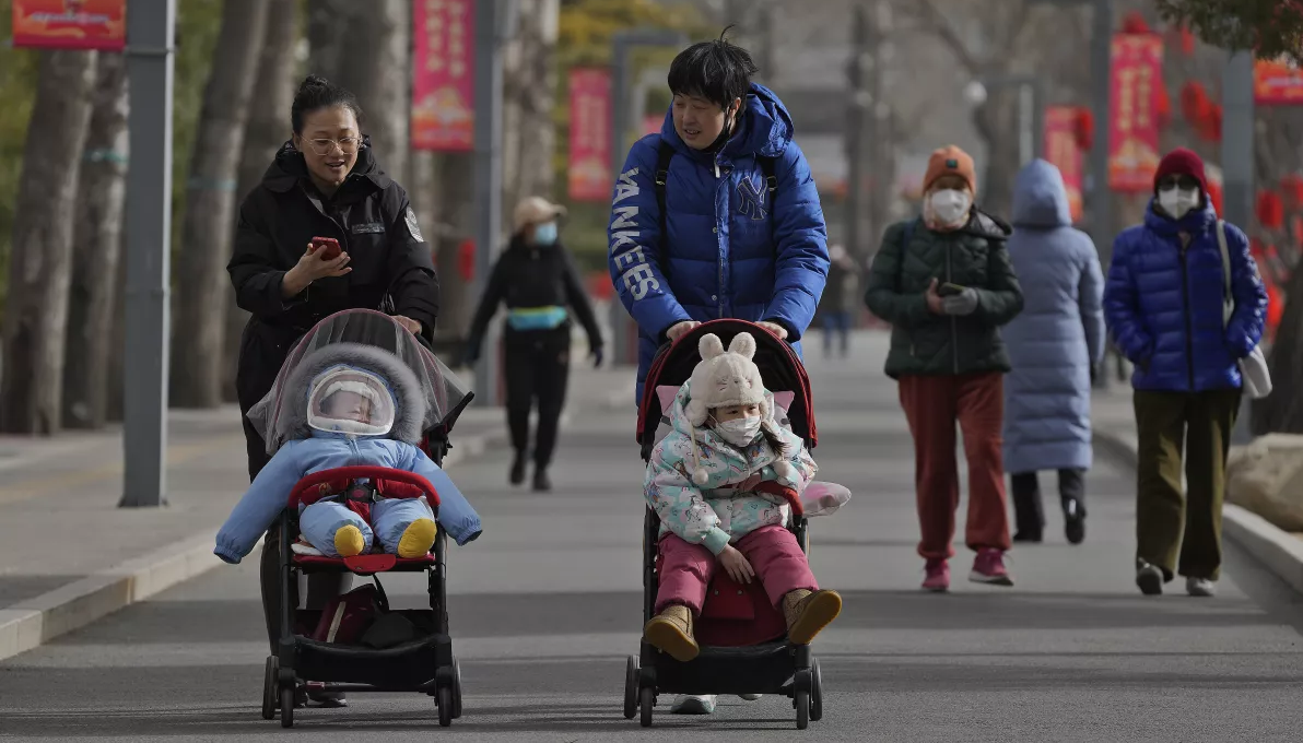 Dos mujeres paseando a sus bebés en China.