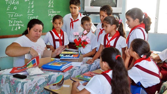 Estudiantes de primaria en Cuba recibiendo libros de texto.