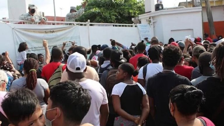 Migrantes a la entrada de un centro de procesamiento en México.
