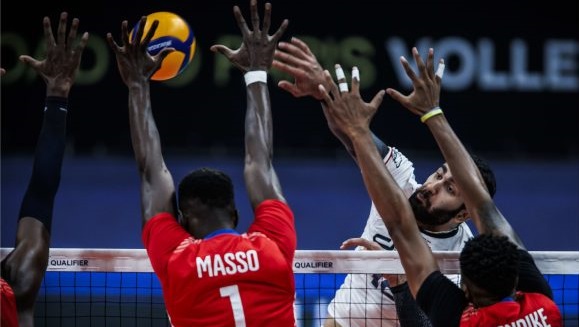 Jugadores de voleibol cubanos bloquean un ataque iraní.