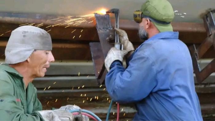 Two welders at a shipyard in Santiago de Cuba.