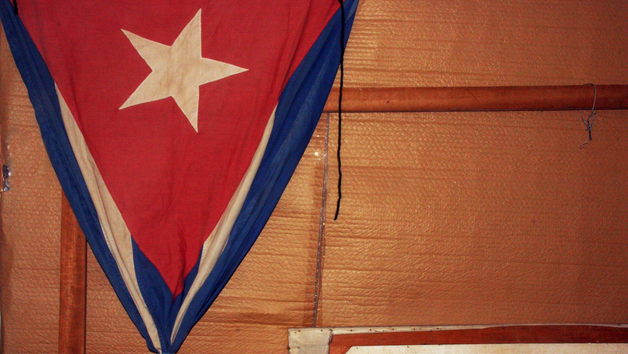 A ragged Cuban flag in an office. 