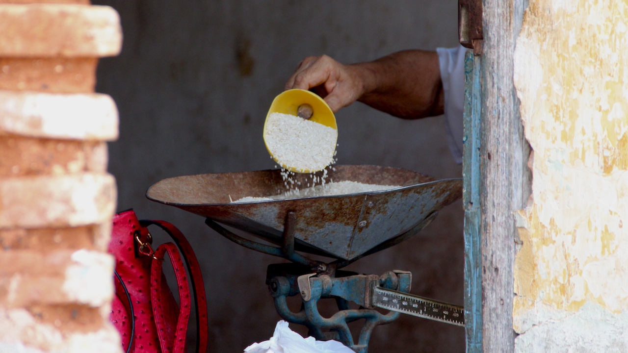 The sale of rice based on the rationing system at a Cuban bodega.