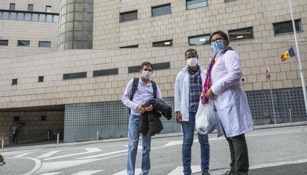 Tres médicos cubanos a las puertas del hospital donde trabajan en Andorra.