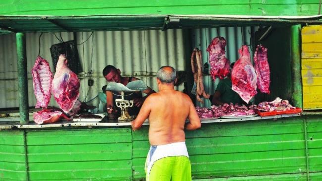 Un cubano compra carne de cerdo en La Habana. 