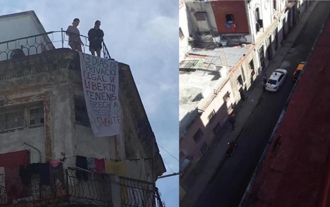 Katherine Bisquer y Camila Lobón colocan un cartel en protesta por la vigilancia policial.