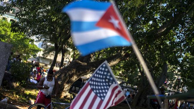 Una bandera cubana y estadounidense en un parque wifi de La Habana.