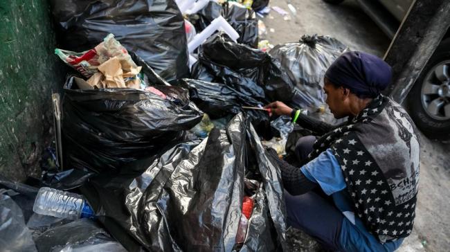 Una mujer busca comida en la basura, en Caracas.