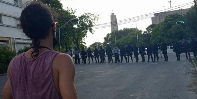 A young Cuban before the cordon of black berets and police that blocked off the Plaza de la Revolución, in Havana.
