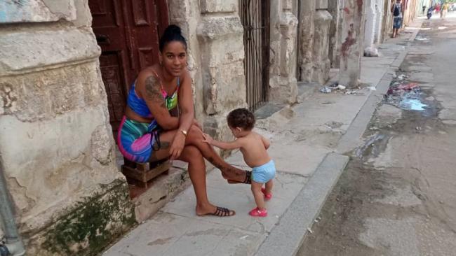 A young Cuban mother at a house in Havana.