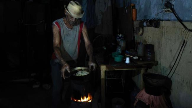 Un cubano cocina con carbón en medio de un apagón en Matanzas.