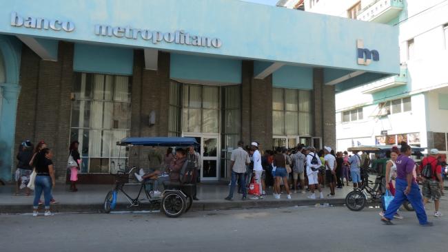 Cola en un banco de La Habana.