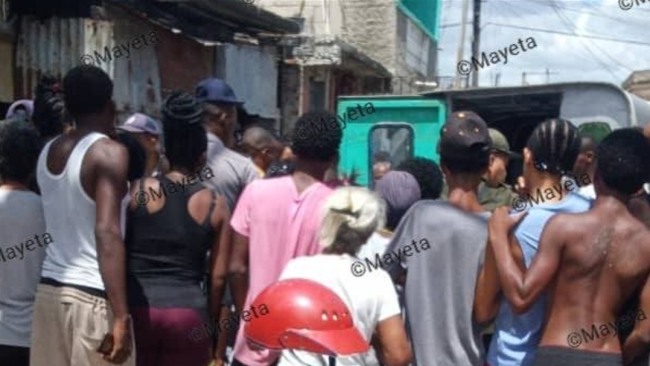 Vecinos alrededor de la vivienda incendiada en Santiago.