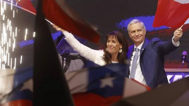 El presidente electo de Chile, el ultraderechista José Antonio Kast, y su esposa, María Pía Adriasola, agitan banderas chilenas, en Santiago (Chile).