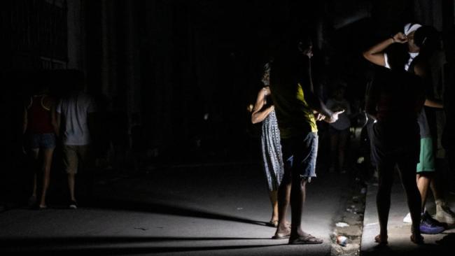 Personas en la calle durante un apagón total en La Habana.
